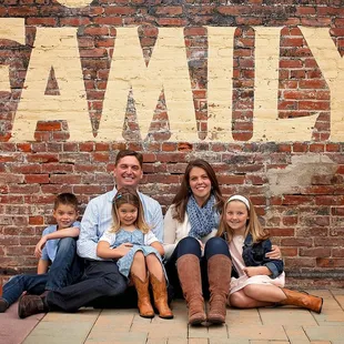 JAX TOYS is locally owned and operated proudly by the Eubanks family!  Here is a shot of us against the wall of our store!