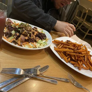 a plate of fries and a salad