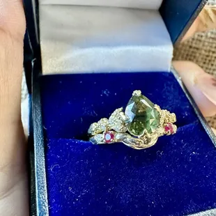 Custom wedding band made with gold and stones given to me as a baby. Engagement ring was made by someone else.