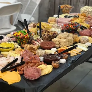 a table full of meats and cheeses