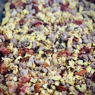 a mixture of eggs, bacon, and sausage