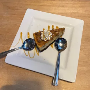 a slice of cheesecake with caramel sauce