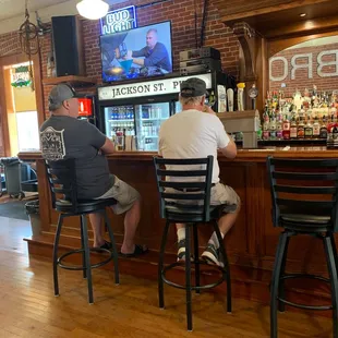 two men sitting at the bar
