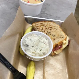 Reuben half sandwich with soup and potato salad