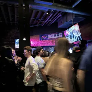a crowd of people at a bar