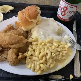 Cajun catfish, roll, mashed potatoes with white gravy, and macaroni and cheese