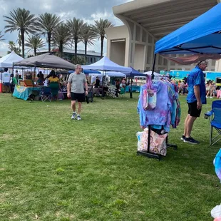 a group of people standing under tents