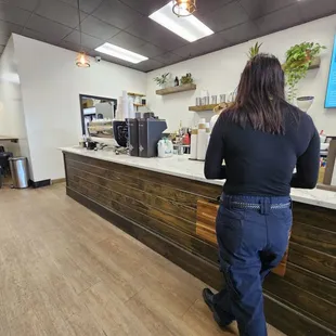 a woman standing in front of a counter