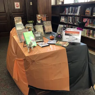 Holiday display table, featuring Halloween themed books and DVDs, found near the "front" door.