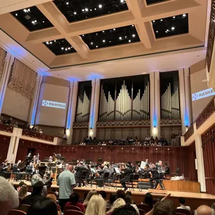 A full picture of the orchestra with the organ pipes in background