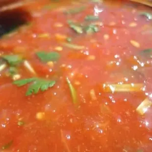 a close up of a bowl of tomato soup