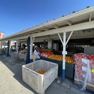 a fruit stand with crates of fruit