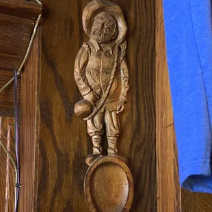 a wood carving of a man