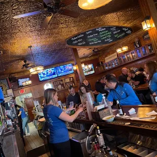 a group of people sitting at a bar