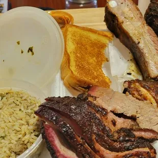 3 meat plate (chicken, ribs, and brisket) with Collard Greens and dirty rice, and buttery Texas Toast