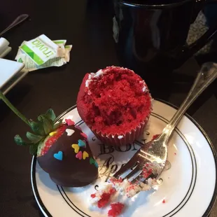 a red velvet cupcake with a bite taken out of it