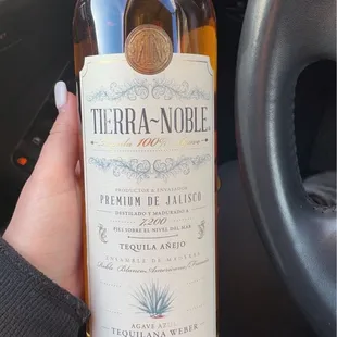 a hand holding a bottle