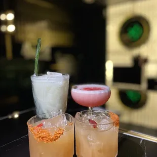 three cocktails on a table