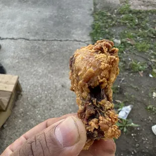 a hand holding a half eaten food item