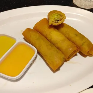 Veggie egg rolls with mustard and sweet and sour sauce
