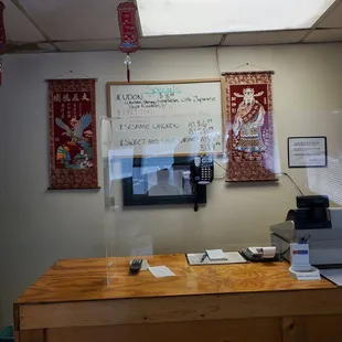 a desk with a computer and a printer