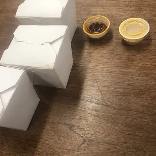 Hot mustard, and chili sauce cups. They were a quarter full.