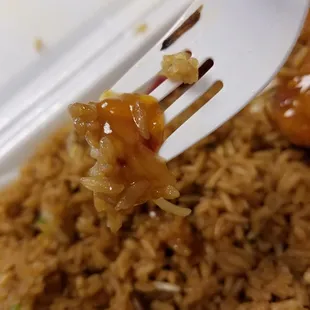 a fork lifting up some rice