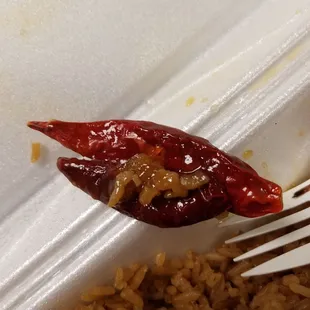 a fork in a container of rice and chili
