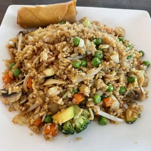 a plate of fried rice and vegetables