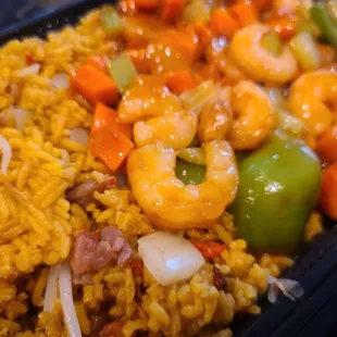 a tray of rice with shrimp and vegetables