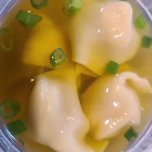 a bowl of soup with dumplings