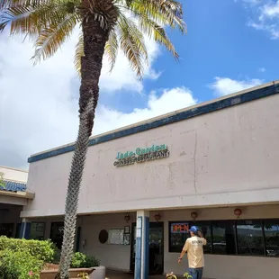 a man walking in front of the restaurant