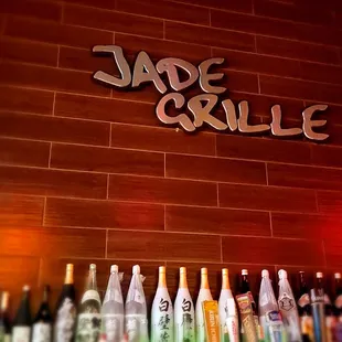 bottles of alcohol lined up on a bar