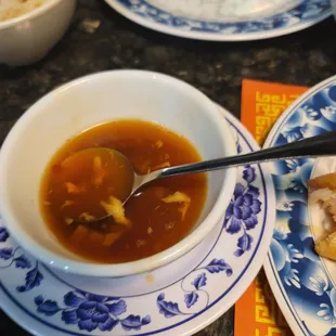 a bowl of soup and a plate of rice