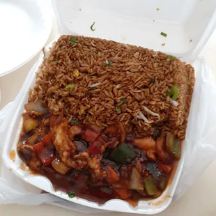 a take out container of rice and vegetables