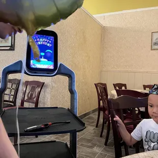 Robot singing happy birthday and a balloon