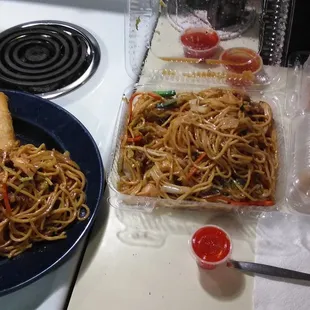 a plate of noodles and rolls