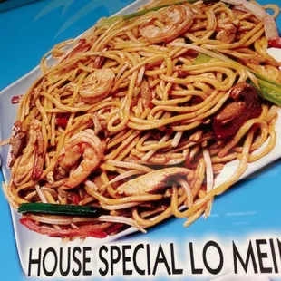 a plate of noodles with shrimp and vegetables