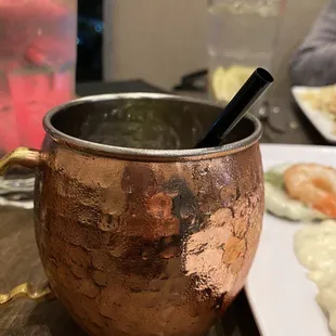 a copper mug with a spoon in it