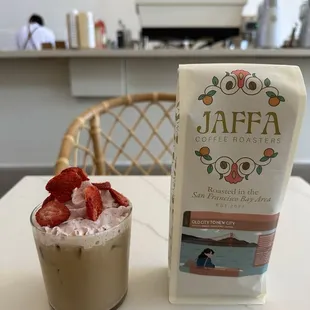 Seasonal mocktail - strawberry sage creek - and roasted coffee beans that say "everyone has the right to return to a cup of Jaffa"