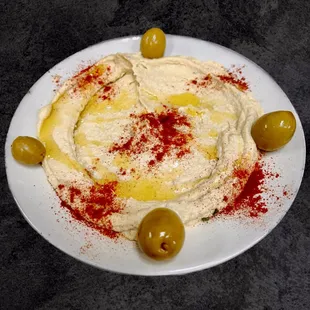 a plate of hummus and olives