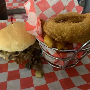 Steak sandwich and half and half bucket (onion rings and fries).