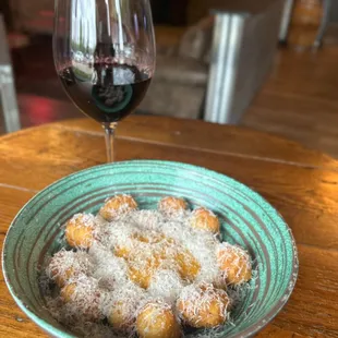 Crispy Parisienne Gnocchi in a tomato gravy and topped with grand Padang cheese.