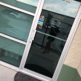the reflection of a woman in the glass door