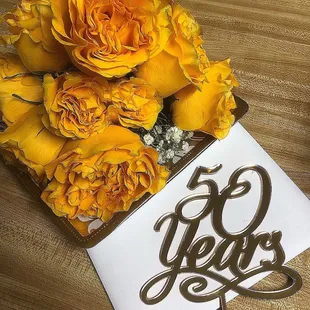 a bouquet of yellow roses in a box