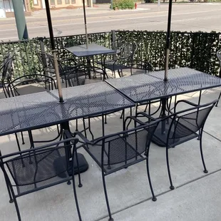 tables and chairs with umbrellas