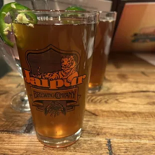 two glasses of beer on a wooden table
