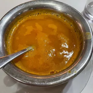 a bowl of soup with a spoon in it