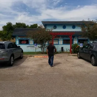 a man walking in front of a restaurant