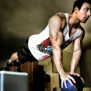 elevated medicine ball pushups, blasting the chest and mostly triceps. The core and abs are engaged also because of the feet